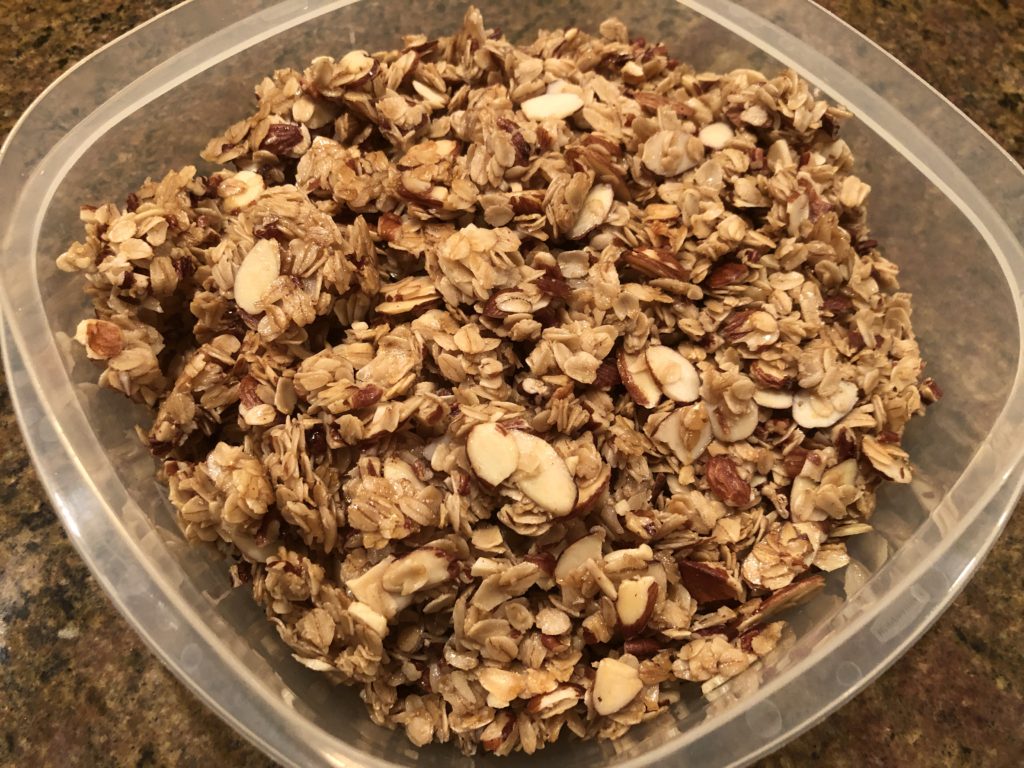 plastic storage container filled with homemade granola
