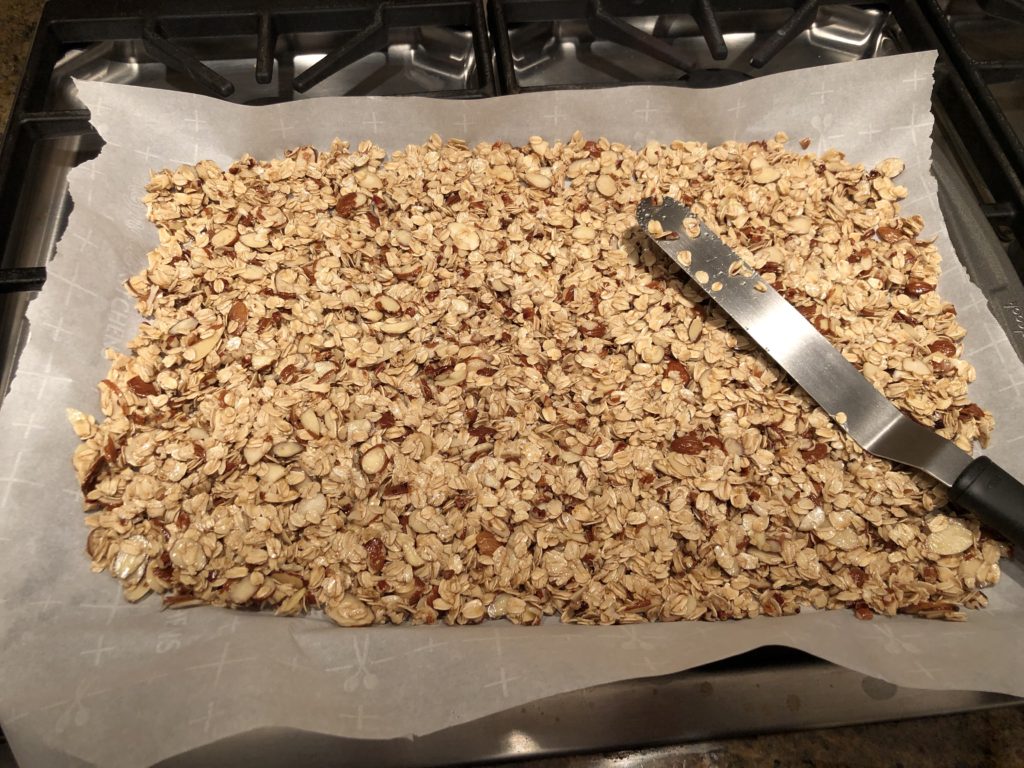 unbaked granola spread on a baking sheet